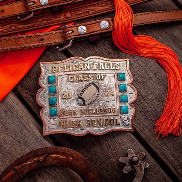 A custom silver and turquoise belt buckle for Pelican Falls High School featuring a football figure 